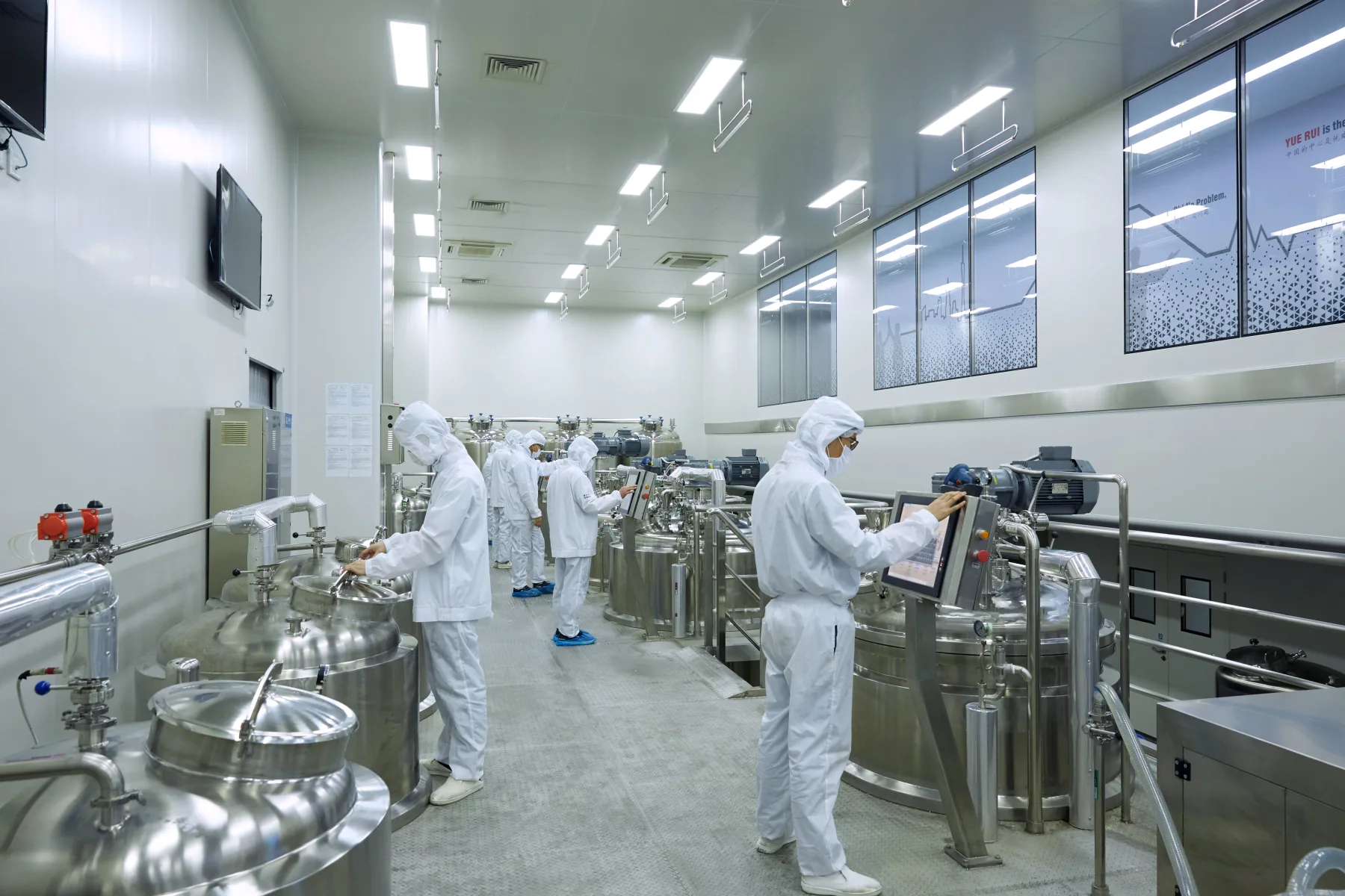 Stainless steel formulation room with production staff